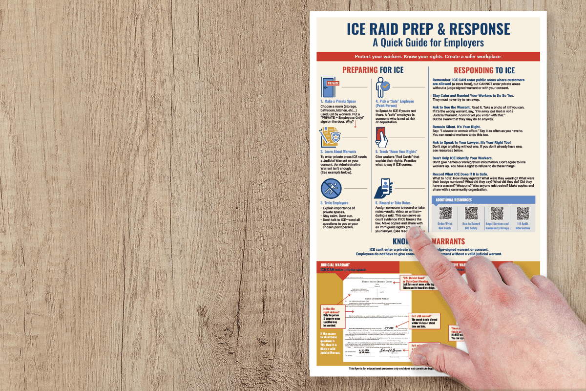 Hand pointing to ICE Prep flyer on workplace wall, showing clear design for small business owners.